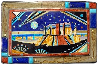 A sterling buckle inlaid with a night scene of a pueblo village under a moon, in turquoise, lapis, jasper and shell.