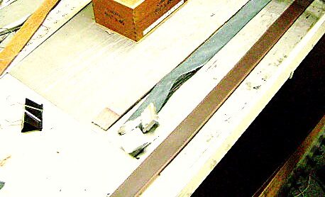 Belt blanks cut and squared on the steel bench, ready to be finished.