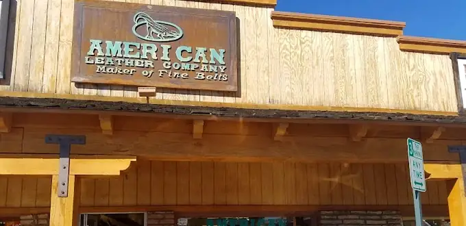The shop front on East 1st Avenue: the carved American Leather Company sign under a shingled awning on timber posts.